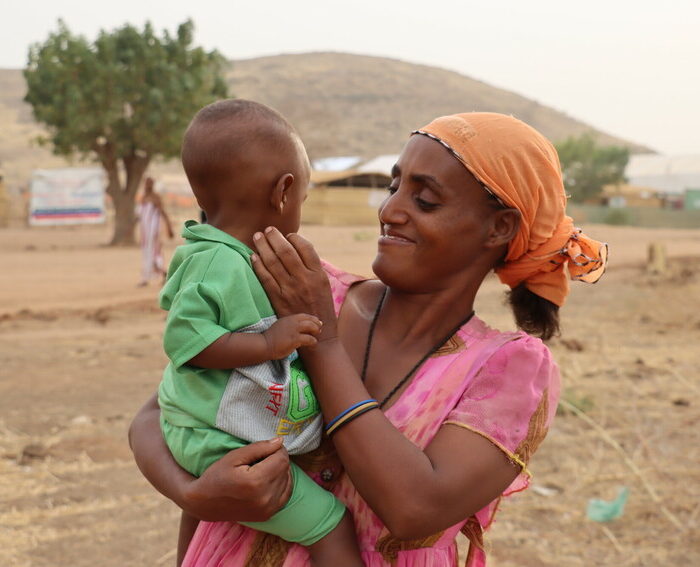 Akbert playing with her youngest 1 year old son, Um-Rakoba Refugees' Camp, Gedarif State, Sudan, February 2021.

This case study follows a 35 years old single mother of 7, Akbert Gebremariaw, from Abderafi, Ethiopia. She lost her husband in the conflict and now&nbsp;settles in Um-Rakuba Refugee&nbsp;Camp, Gedarif State, Sudan. The study describes what happened back home and her day to day activities. 

The Um-Rakuba Refugee Camp in Gedarif Sate of Sudan is currently home to over 20,000 refugees who have fled&nbsp;conflict in Ethiopia.&nbsp;Islamic Relief has responded to the refugee crisis since November 2020 and has provided food items among other essential items. Islamic Relief has also provided non-food items such as kitchen utensils and also hygeine kits for women and girls. We have also built latrines and washing facilities at the camp.&nbsp;Islamic Relief continues to work at Um-Rakuba Refugee Camp providing the most essential assistance to the refugees.&nbsp;